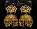 Traditional gold-tone jhumka earrings with green beads, pearl detailing and white stones